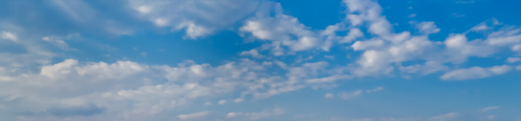 Naklejka na ściany i meble Blue sky with white clouds as a background