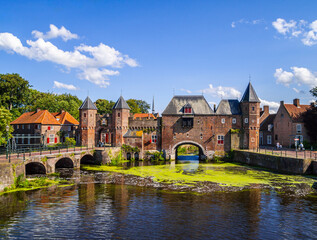 Fototapeta premium Medieval brick, city gate over the water on a beautiful sunny day