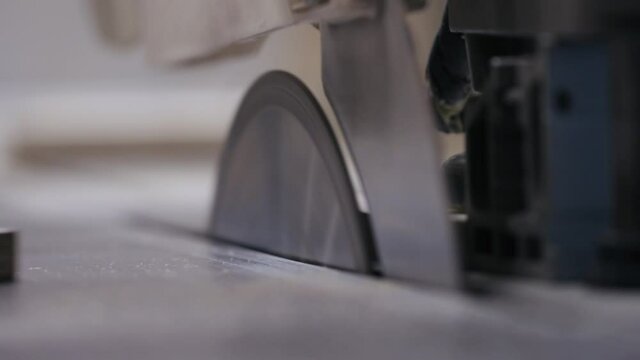 Cutting process on circular saw in closeup
