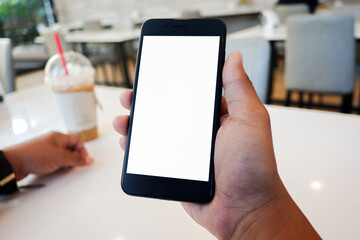 Cropped shot view of man’s Hands hold the smartphone with blank copy space screen for your information content or text message on the gray granite at the modern place.