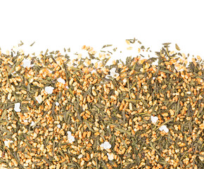 Japanese green tea Genmaicha, isolated on white background. Tea leaves with roasted brown rice. Organic tea. Top view. Close up.