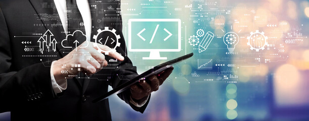 Web development concept with businessman using his tablet computer