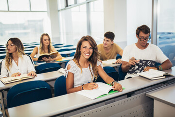 University students studying together in classroom.