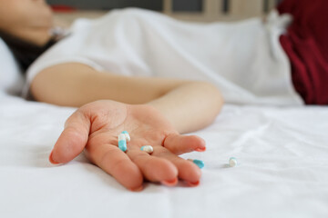 Close up of woman hand with many pills. Drug addiction and social issue for teenager. Take an overdose concept