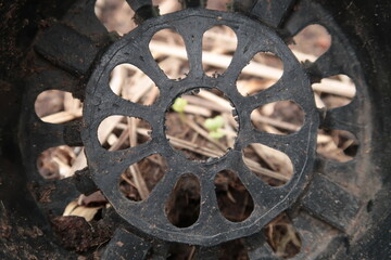 Background of inside an old black plastic plant pot with full of drainage holes on the bottom and dirty with soil.