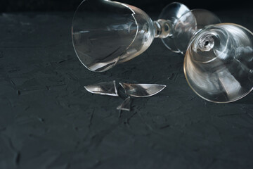Broken and normal wine glass on a black background with copy space