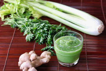  green smoothie of celery ,parsley and ginger in glass
