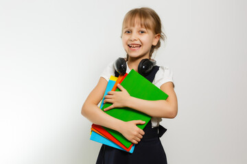 Blonde schoolgirl holds large book, shoot over white background