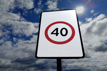Road sign against clouds and sun. Front view