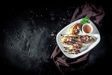 Bruschetta with tomatoes, mozzarella cheese and basil on dark background. Traditional italian appetizer or snack, antipasto