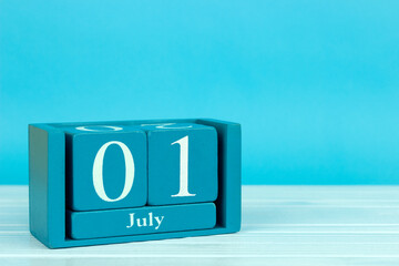 wooden calendar with the date of july 1 on a blue wooden background, Scottish Heritage Holiday, World Poverty Day