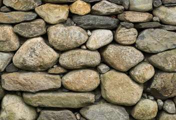 Fototapeta na wymiar Rock wall of natural rounded river stones