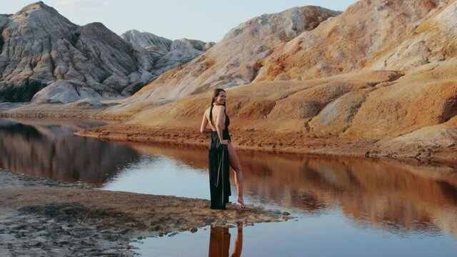 Beautiful woman posing on other-worldly hilly landscape