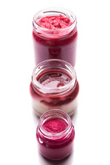 Nutrition concept - Healthy food, Diet, Detox, Clean Eating or Vegetarian concept. A nutritious food on glass jars against white background. Fruit pie in a glass. Dessert