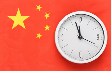 White clock on background of China flag