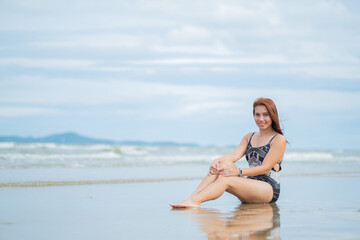Fototapeta na wymiar young woman sitting on beach, travel on holidays, girl enjoying at summer. relax on beach. happy time, vocation 