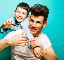 young pretty man model with little cute son playing together, lifestyle modern people concept, family male