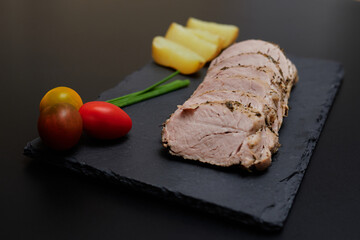 pork tenderloin cut on top of a blackboard