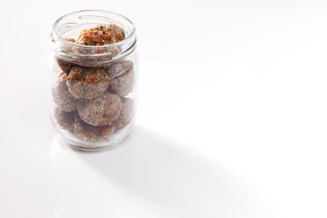 Nutrition concept - Healthy food, Diet, Detox, Clean Eating or Vegetarian concept. A nutritious food on glass jars against white background. Meat balls in a jar.