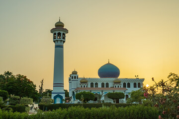 beautiful mosque on a background of clouds around the greens