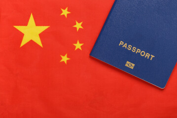 Travel concept. Passport against the background of the China flag