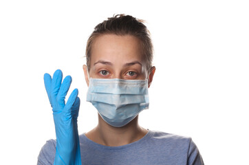 Portrait of a woman in a medical mask and gloves isolated on white background. Pandemic protection covid-19