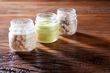 Nutrition concept - Healthy food, Diet, Detox, Clean Eating or Vegetarian concept. A glass jar of nutritious food against wooden background. Delicious take away food in glass jars.