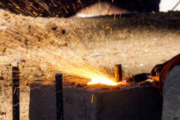 The welder cutting the rebars with oxy fuel. The oxyfuel process is the most widely applied...