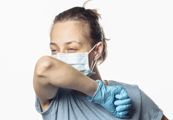 Symptoms of the flu. Woman in medical mask coughs isolated on a white background. Covid-19.