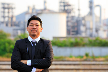 The smart senior project manager standing over the refinery plant
