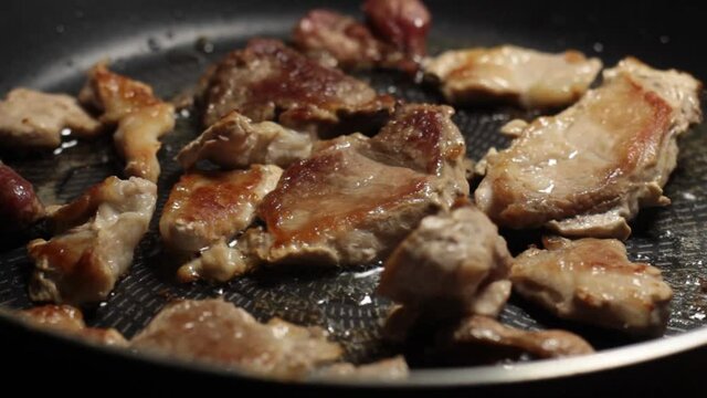 the pan with meat rotates counterclockwise