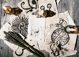 old manuscripts with occult symbols, candles, lavender. Concept of fortune telling, ritual, altar,...