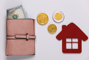 Family, home budget. The concept of buying or paying for housing Wallet with money, house figurine...