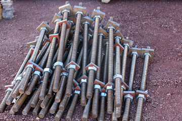View of the group of steel anchor bolts, nuts and washers in the construction site. Anchor bolts are used to connect structural and non-structural elements to the concrete. © Funtay