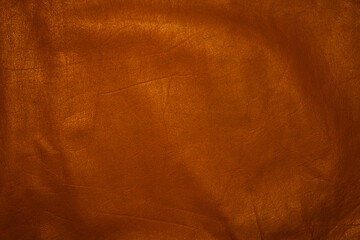 Naklejka premium Background, leather texture of a copper shade.