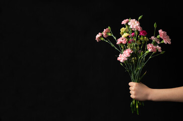 Bouquet In School Student Hand on Black Chalkboard Background