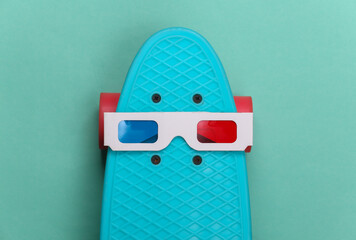 Anaglyph 3D glasses on cruiser board. Mint green background. Hipster outfit. Entertainment 80s. Top...