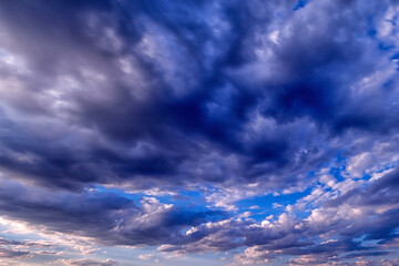 Background of the black and white cumulus clouds under the beautiful blue sky. Clouds exert...