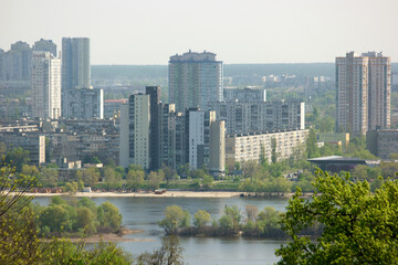 Fototapeta na wymiar Landscape view of Kyiv on Dnipro river. View of Dnieper river with modern buildings in the background. Kiev, Ukraine.