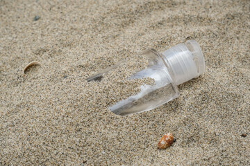 Fototapeta na wymiar Plastic hand sanitizer,disposable medical garbage on sea coast,coronavirus covid pollution disease,dirty ecosystem