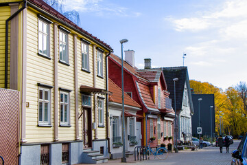 Fototapeta premium Old village wooden house in Parnu, Estonia. Village near baltic sea, resort for summer holidays. People in the street.