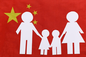 Paper cut family chain on background of China flag. Patriotism theme