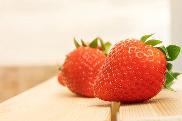 Ripe juicy sweet strawberries on a wooden background