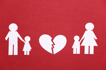 Broken family, divorce. Split paper family, broken heart on a red background