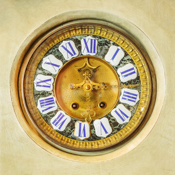 Authentic ornamental golden clock with enamel roman numbers