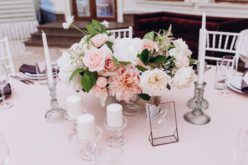 Flower decoration of wedding tables.
Banquet table setting and decoration. Cutlery on the table. 