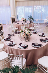 Flower decoration of wedding tables.
Banquet table setting and decoration. Cutlery on the table. 