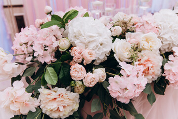 Beautiful wedding bouquet. Delicate petals of white and red roses.