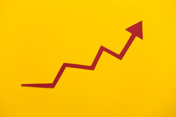 Red growth arrow on yellow background. Arrow graph going up. The economic growth