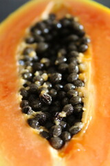 Seeds inside one half of a papaya fruit.